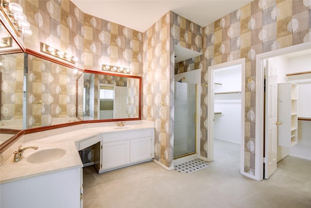 full bath with double vanity, a stall shower, a sink, and tile walls