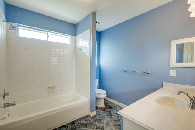 bathroom featuring baseboards, toilet, tile patterned floors, vanity, and shower / bathing tub combination