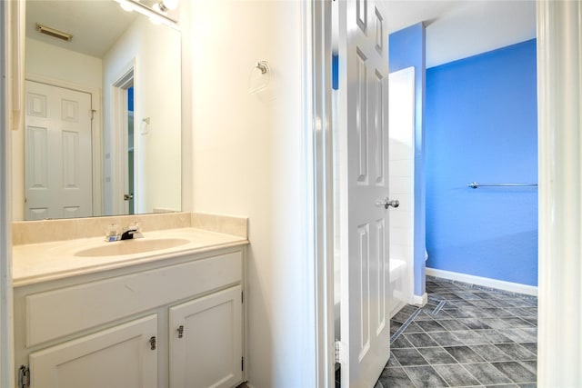 bathroom featuring baseboards, visible vents, and vanity