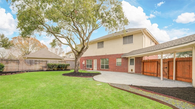 rear view of house with brick siding, a lawn, a patio area, and a fenced backyard