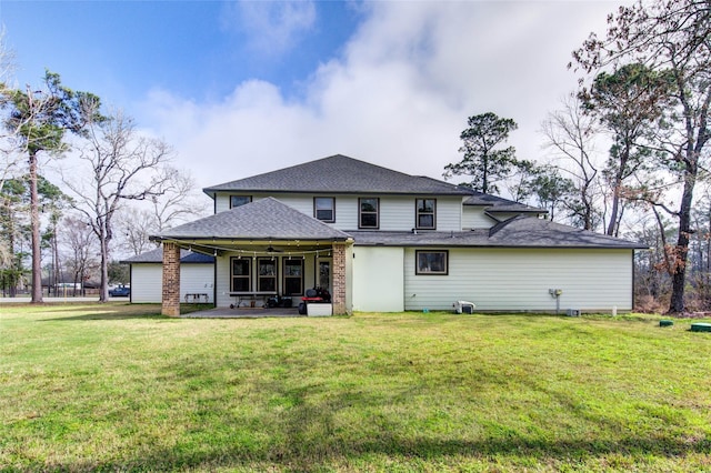 back of property featuring a patio area, ceiling fan, a shingled roof, and a lawn