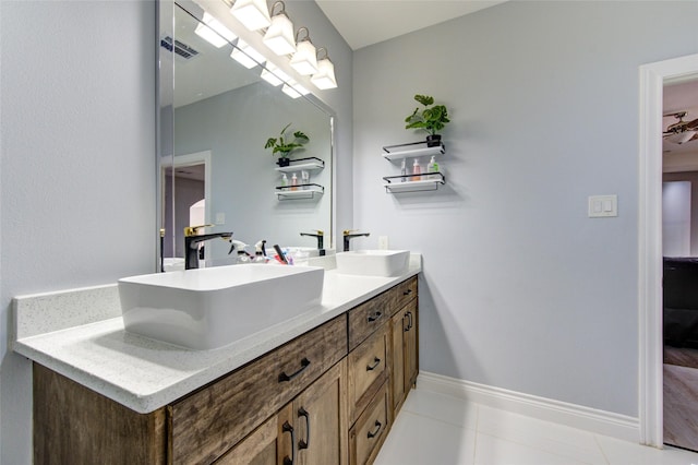 full bathroom featuring double vanity, baseboards, visible vents, and a sink