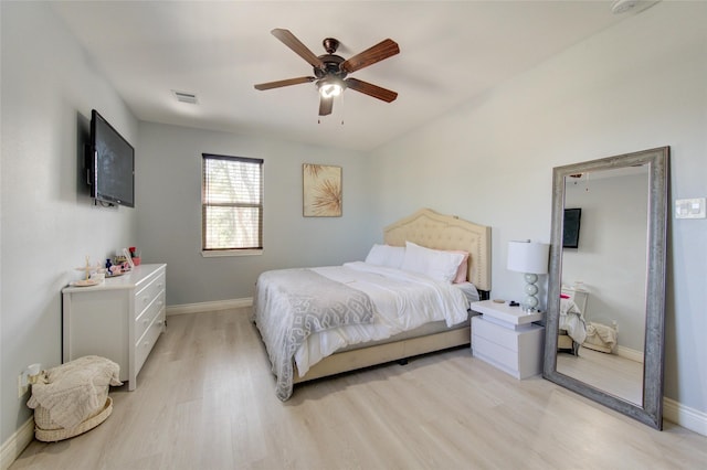 bedroom with light wood-type flooring, visible vents, baseboards, and a ceiling fan