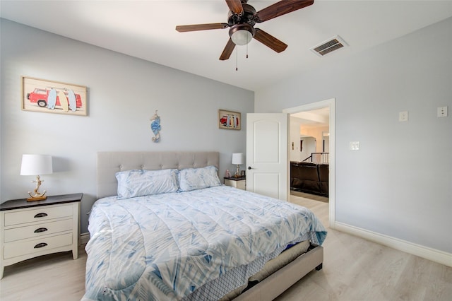 bedroom with baseboards, visible vents, light wood-style flooring, and a ceiling fan