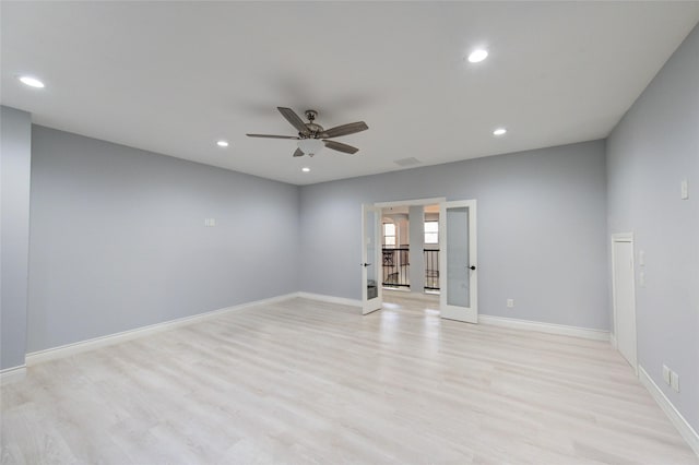 spare room featuring light wood-type flooring, baseboards, and recessed lighting