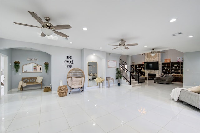 living room featuring light tile patterned floors, a fireplace, visible vents, and recessed lighting