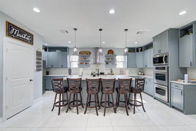 kitchen featuring stainless steel appliances, visible vents, and open shelves