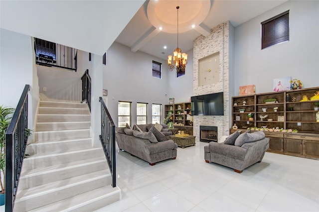 living room featuring a fireplace, a towering ceiling, a chandelier, beamed ceiling, and stairs