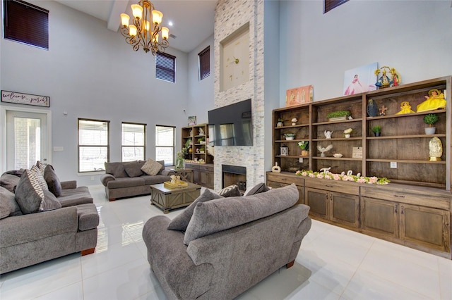 living room featuring a notable chandelier, a stone fireplace, a high ceiling, and light tile patterned floors