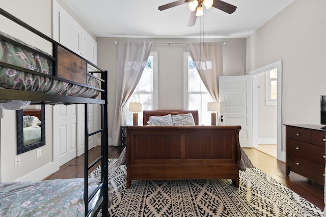 bedroom with baseboards, a ceiling fan, and wood finished floors