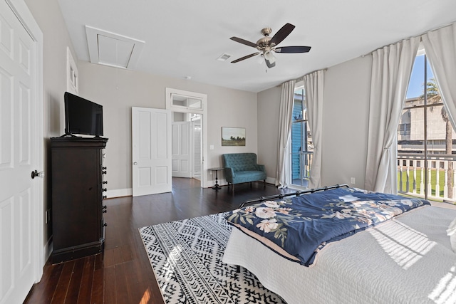 bedroom with visible vents, attic access, ceiling fan, wood finished floors, and baseboards