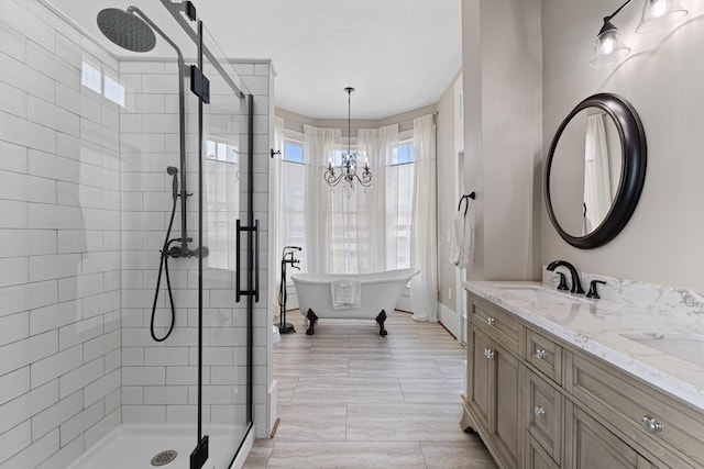 full bath with a stall shower, a sink, a freestanding bath, and double vanity