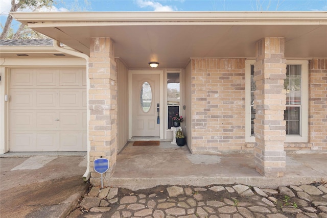 view of exterior entry featuring brick siding