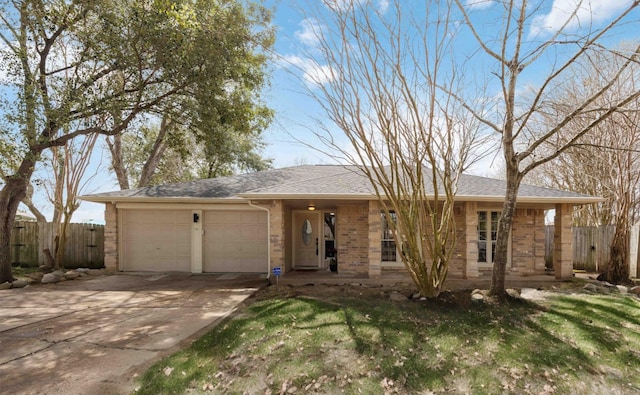 ranch-style home featuring a garage, concrete driveway, roof with shingles, fence, and brick siding