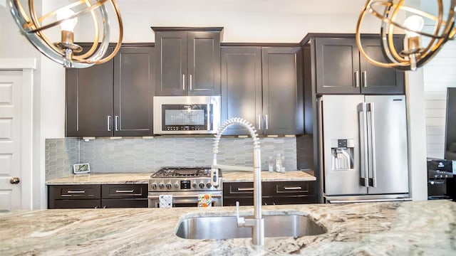 kitchen featuring light stone countertops, high quality appliances, backsplash, and dark brown cabinets