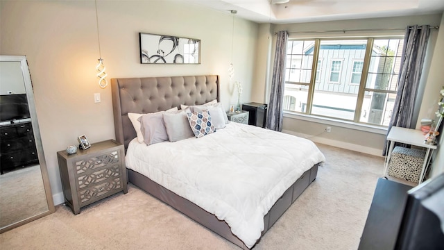 carpeted bedroom featuring baseboards