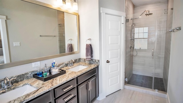 bathroom featuring double vanity, a sink, and a shower stall