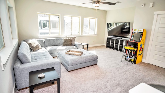 living area with ceiling fan, carpet, visible vents, and baseboards