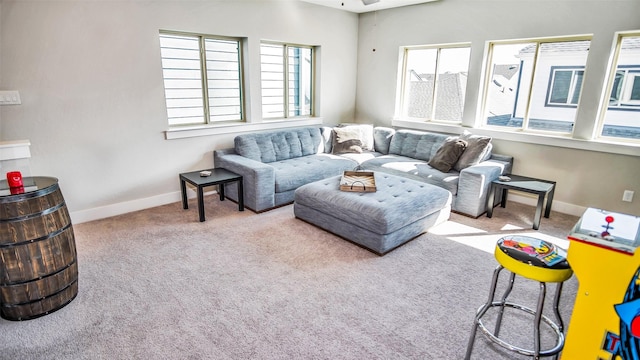 carpeted living room featuring baseboards