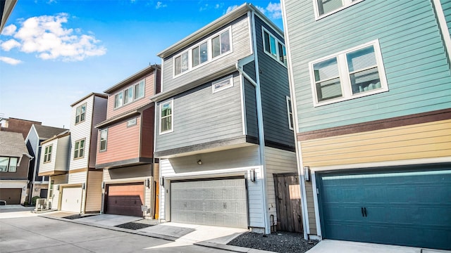 townhome / multi-family property featuring an attached garage and a residential view