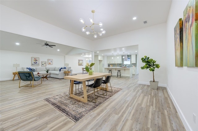 dining room with light wood-style floors, visible vents, and baseboards