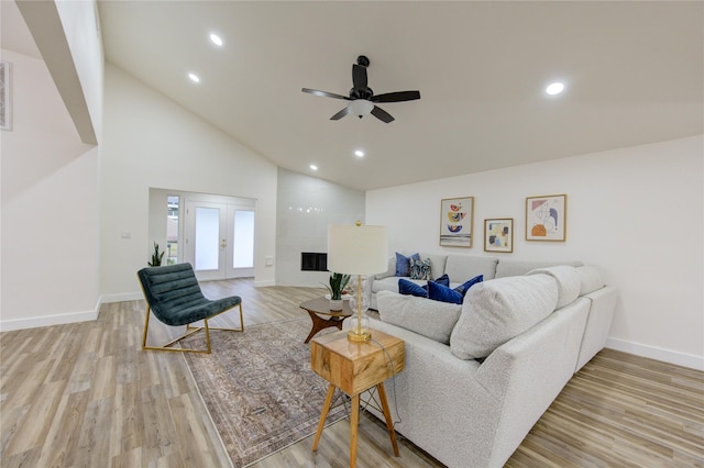 living room featuring light wood finished floors, recessed lighting, and french doors