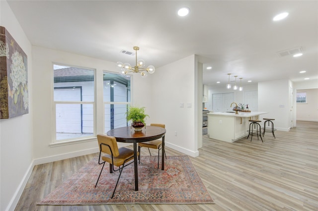 dining room featuring light wood-type flooring, visible vents, and recessed lighting