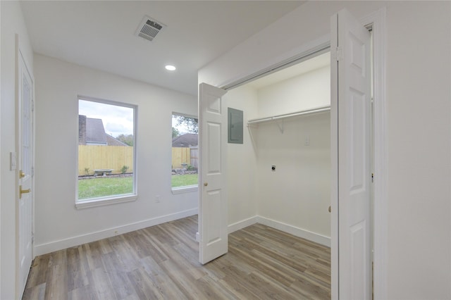 washroom with laundry area, visible vents, baseboards, light wood-type flooring, and electric dryer hookup