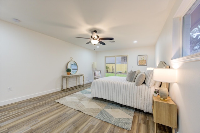 bedroom with a ceiling fan, access to outside, baseboards, and wood finished floors