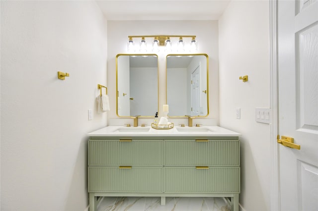 bathroom with marble finish floor, double vanity, and a sink