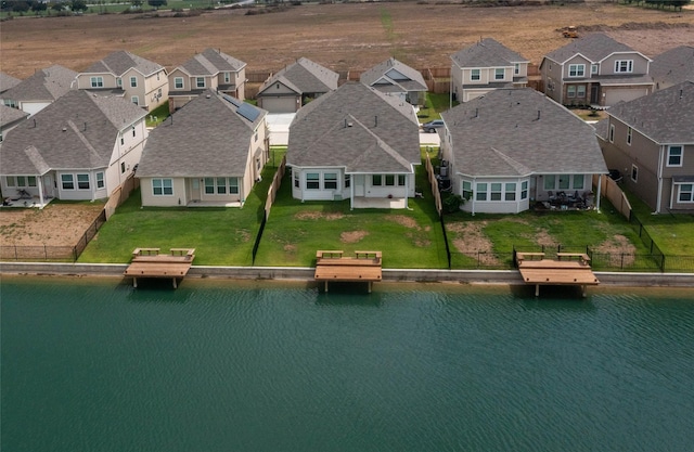 drone / aerial view with a water view and a residential view