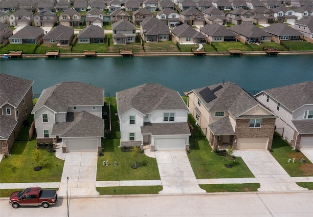 drone / aerial view featuring a water view and a residential view