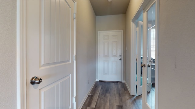 entryway featuring baseboards and dark wood finished floors