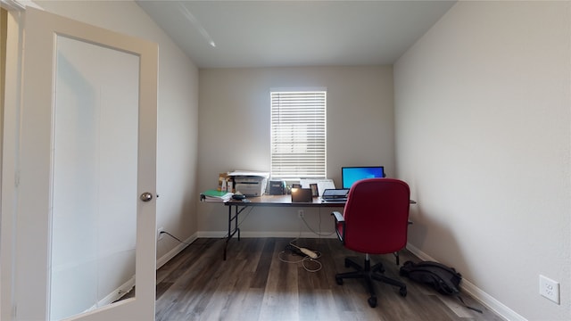 office space with baseboards and wood finished floors