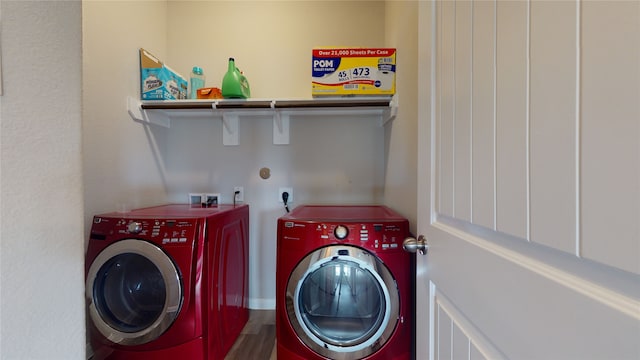 laundry room with laundry area, wood finished floors, and washing machine and dryer