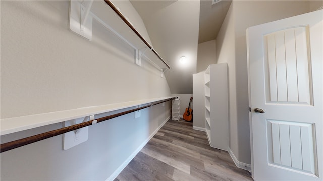 walk in closet with light wood-style flooring