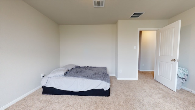 carpeted bedroom with baseboards and visible vents