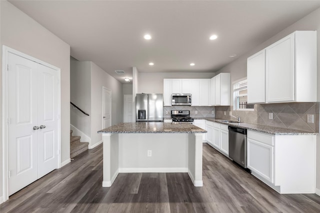 24902 Bastiani Canvas Ln, Katy, TX 77493 - kitchen featuring stainless steel appliances, dark wood-style flooring, backsplash, stone counters, and white cabinets