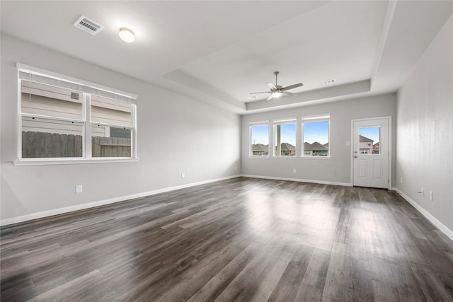 24902 Bastiani Canvas Ln, Katy, TX 77493 - unfurnished room featuring a raised ceiling, a ceiling fan, dark wood-style floors, and baseboards