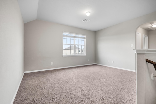 24902 Bastiani Canvas Ln, Katy, TX 77493 - unfurnished living room featuring carpet, baseboards, arched walkways, and vaulted ceiling