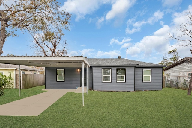 view of front of property with roof with shingles, fence, and a front lawn