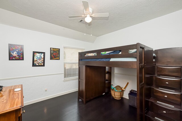 bedroom featuring a textured ceiling, wood finished floors, a ceiling fan, visible vents, and baseboards