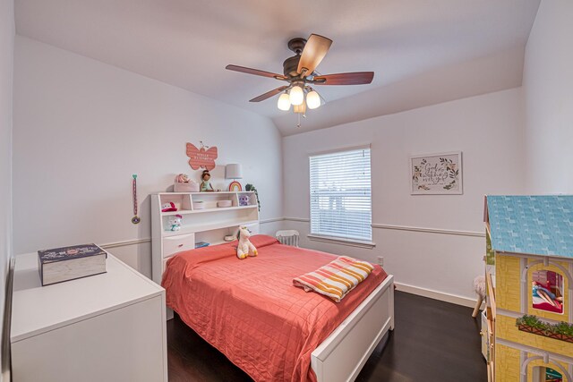 bedroom with lofted ceiling, ceiling fan, dark wood-style flooring, and baseboards