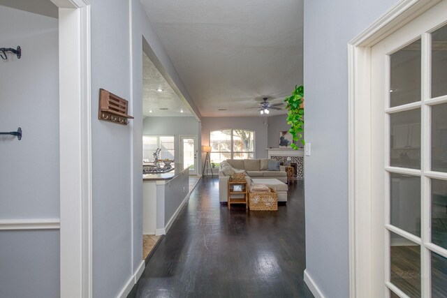 hall featuring dark wood-style floors and baseboards