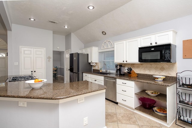 kitchen with appliances with stainless steel finishes, visible vents, a sink, and white cabinetry