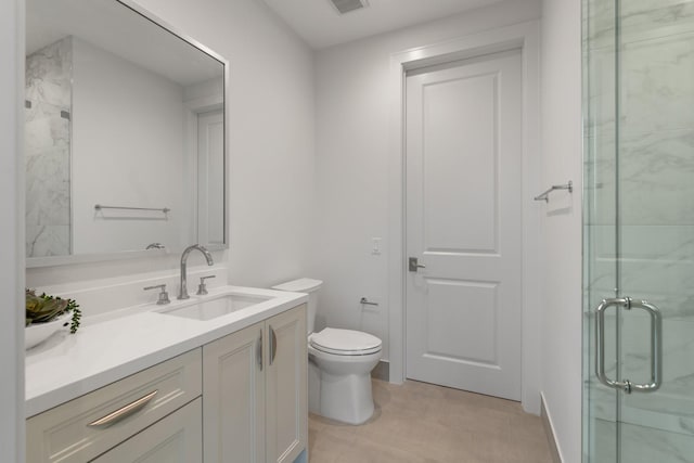 bathroom with a shower stall, vanity, and toilet