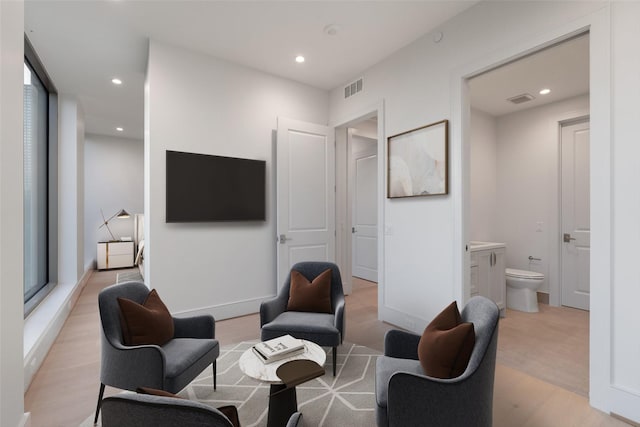 sitting room featuring recessed lighting, light wood-style floors, and visible vents