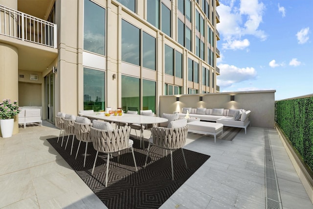 view of patio / terrace with outdoor dining space, an outdoor living space, and a balcony