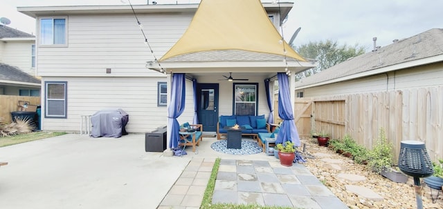 rear view of house with outdoor lounge area, a patio area, fence, and a ceiling fan