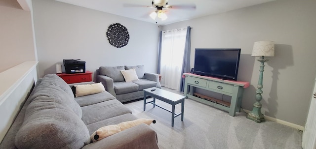 carpeted living area featuring ceiling fan and baseboards